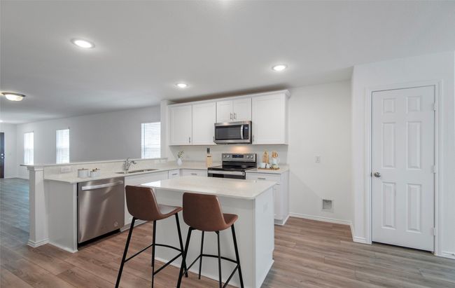 Eat-in island kitchen *Photos of furnished model. Not actual home. Representative of floor plan. Some options and features may vary | Image 6