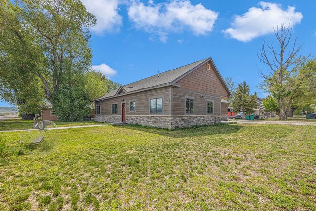 View of side of home featuring a lawn and stone siding | Image 6