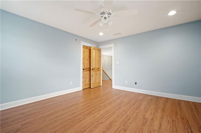 Unfurnished room featuring light wood-style flooring, baseboards, visible vents, ceiling fan, and recessed lighting | Image 23