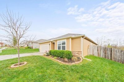 View of property exterior featuring a garage and a yard | Image 2