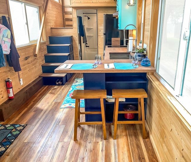 Dining room with wooden walls, wood finished floors, and stairs | Image 21