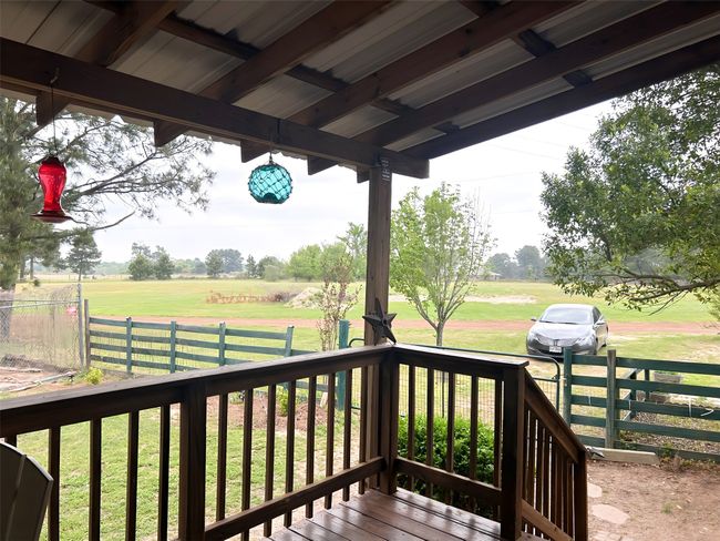 Wooden terrace featuring a lawn, fence, and a rural viewm | Image 30