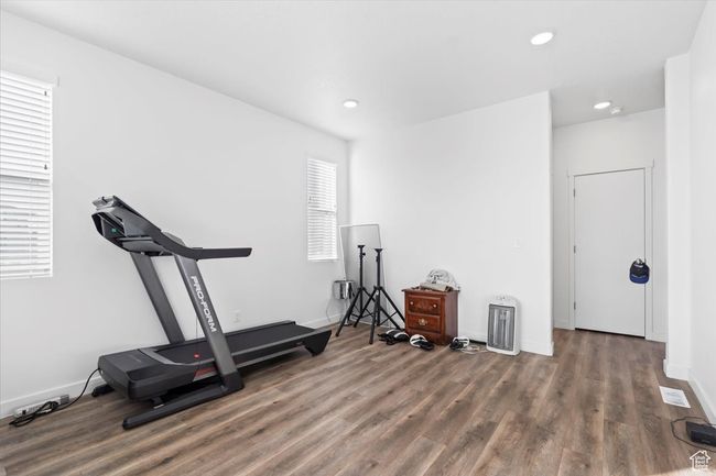 Workout room featuring baseboards, wood finished floors, visible vents, and recessed lighting | Image 15