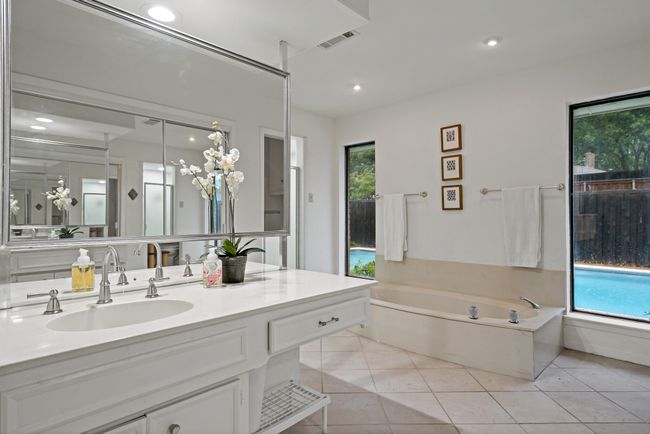 Full bath featuring tile floors, a garden tub, and vanity | Image 9