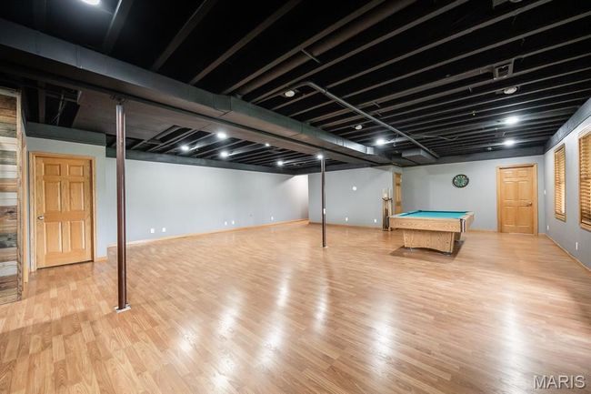 Finished below grade area featuring wood finished floors, billiards, and baseboards | Image 37