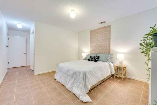 Bedroom with light tile patterned floors and baseboards | Image 19