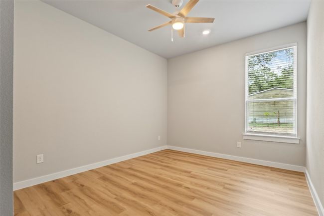 A bright, spacious bedroom with natural light and generous closet space—shown from a fresh angle to highlight its inviting charm. | Image 26