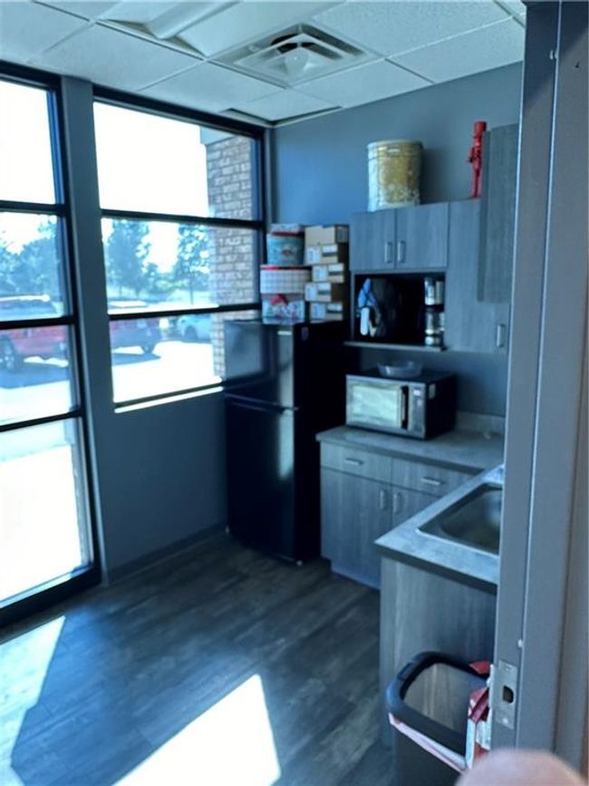 Kitchen with a paneled ceiling, dark hardwood / wood-style flooring, and a healthy amount of sunlight | Image 15