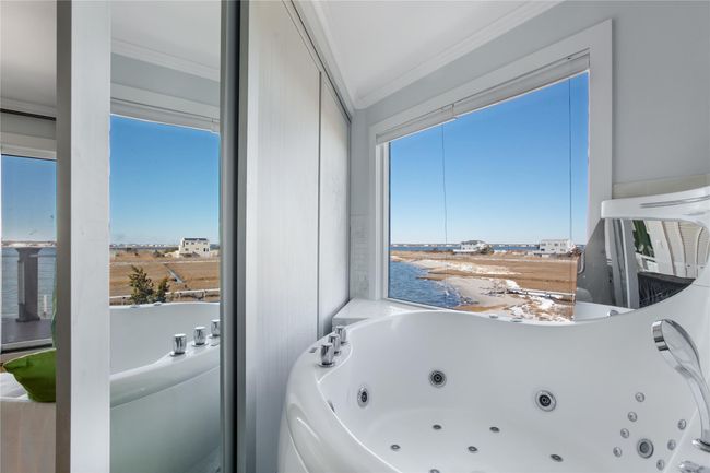 Bathroom featuring a jetted tub and crown molding | Image 7