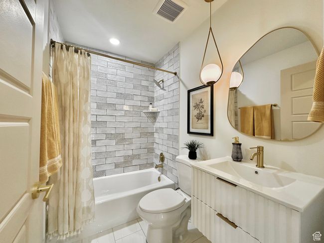 Bathroom featuring vanity, shower / tub combo, and tile patterned floors | Image 24