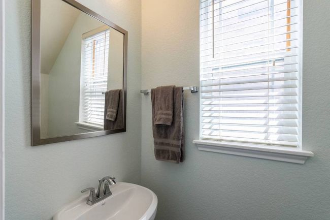 Bathroom featuring plenty of natural light and a textured wall | Image 23