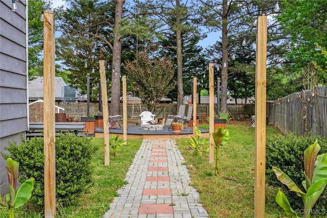 View of yard featuring a wooden deck and a fenced backyard | Image 29