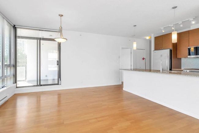 Unfurnished living room with light wood finished floors and rail lighting | Image 8