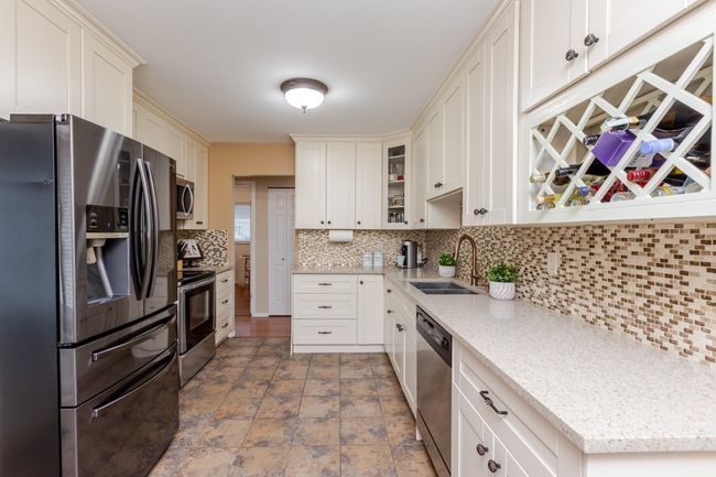 Tastefully renovated kitchen with newer appliances and faucet | Image 11