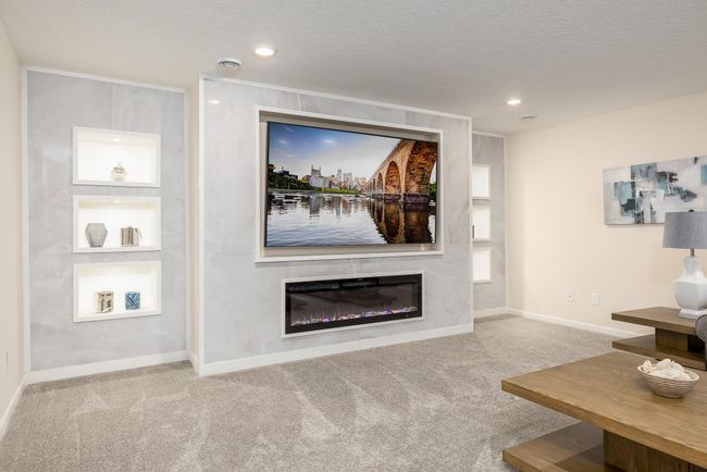 Closer look at the lower level accent wall, featuring floor to ceiling ceramic tile with built-in storage areas illuminated by lighting! | Image 27