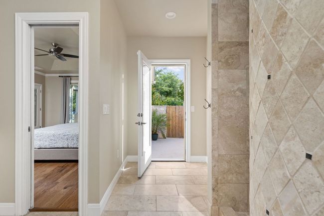 A glass door provides direct access to the private outdoor shower. | Image 18