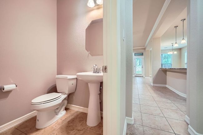 Bathroom featuring tile patterned floors and a chandelier | Image 15