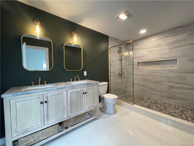 Example of the work we do. Not this house. Bathroom with dual vanity, tile patterned floors, walk in shower, and toilet | Image 14