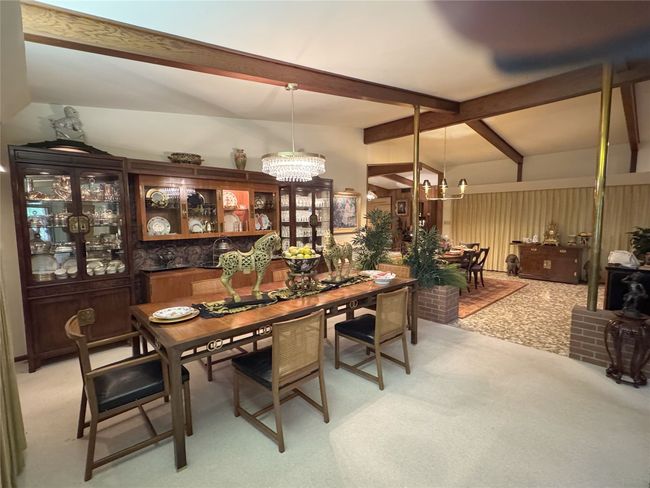 Dining area featuring a chandelier and light carpet | Image 20