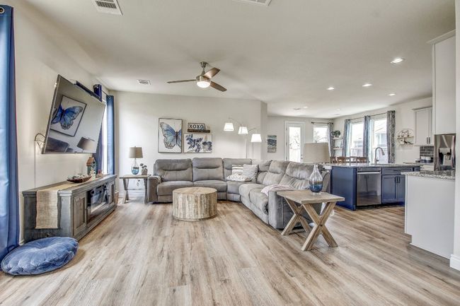 Living room featuring light wood-style flooring, recessed lighting, and a ceiling fan | Image 4