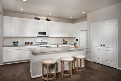 This kitchen is by far any chef’s dream! This spacious kitchen features a large kitchen island with double sink, high ceilings, white stained wood cabinets, granite countertops, modern tile backsplash, recessed lighting, space for breakfast bar, and a walk-in pantry all overlooking your huge family room! | Image 2