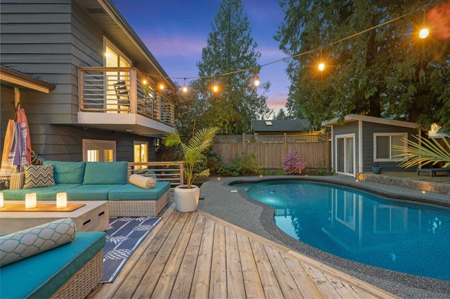 View of swimming pool featuring a fenced in pool, an outdoor living space, fence, and an outbuilding | Image 37