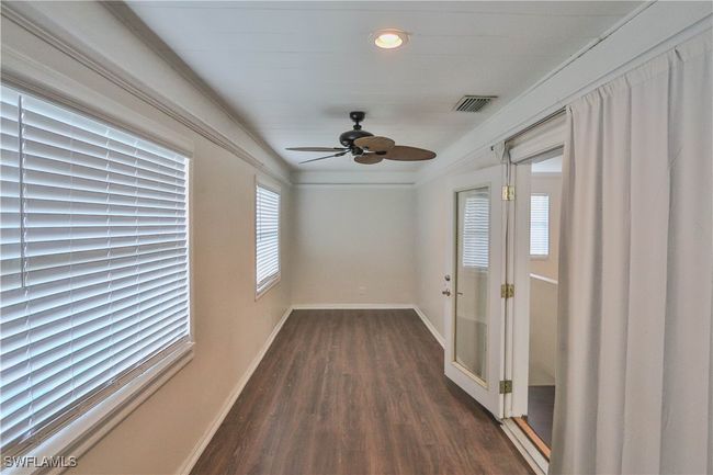 Empty room featuring dark wood-type flooring, a ceiling fan, baseboards, and recessed lighting | Image 19