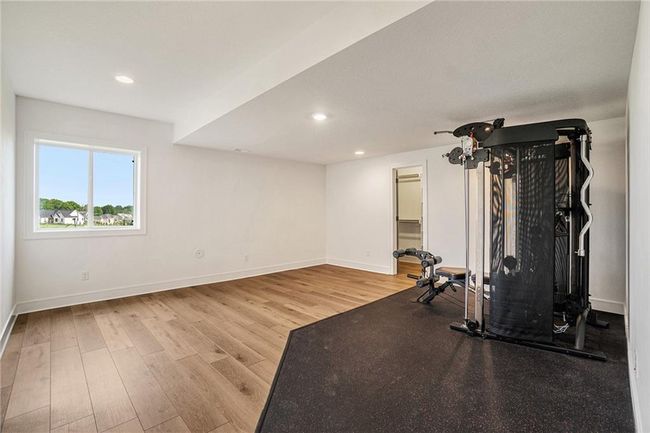 Exercise room featuring baseboards, wood finished floors, and recessed lighting | Image 47
