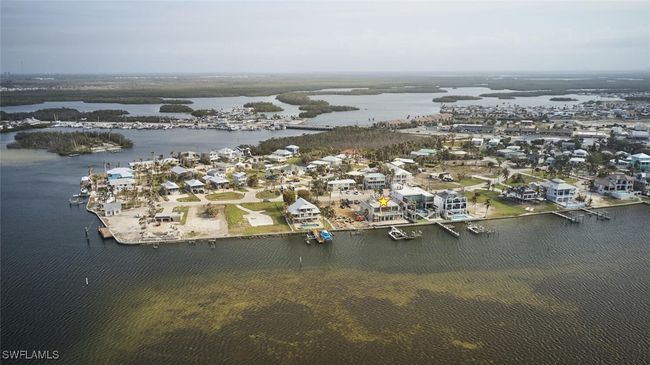 Aerial view of property and surrounding area with a large body of water and nearby suburban area | Image 38