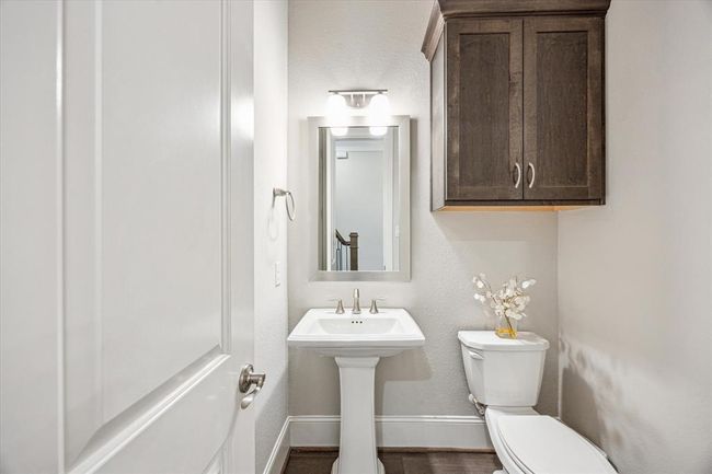 This powder room is tucked behind the staircase. | Image 17