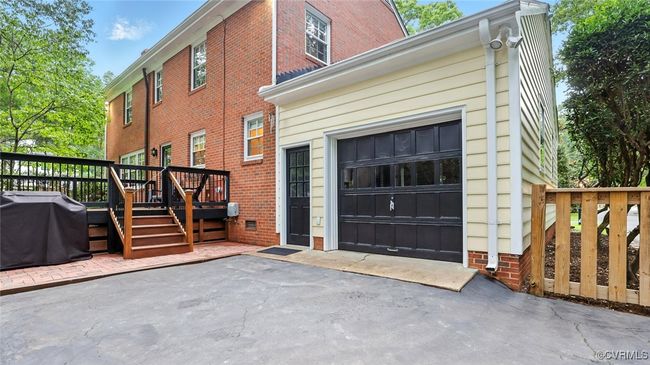 View of side of property with a garage, brick siding, and a​​‌​​​​‌​​‌‌​‌‌​​​‌‌​​‌‌​‌​​​​​‌ deck | Image 13
