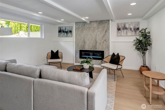 Lower level living room with electric fireplace. | Image 16