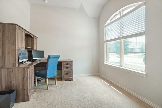 Home office featuring light colored carpet, baseboards, and lofted ceiling | Image 13