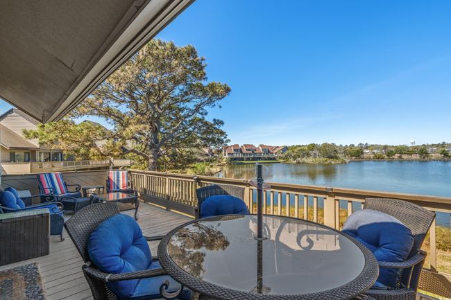 Wooden deck featuring outdoor dining area and a water view | Image 20