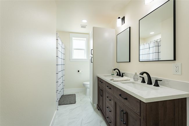 Bathroom featuring marble finish floor, a sink, toilet, and baseboards | Image 10