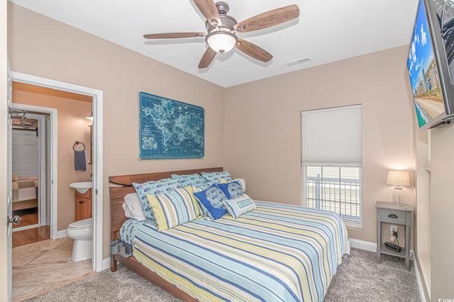 Bedroom featuring ensuite bath and a ceiling fan | Image 19