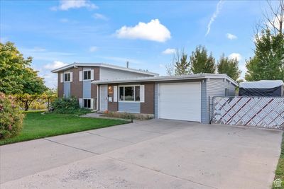 View of front facade featuring a front yard and a garage | Image 2