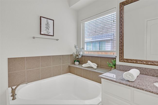 Bathroom with a bath and vanity | Image 15