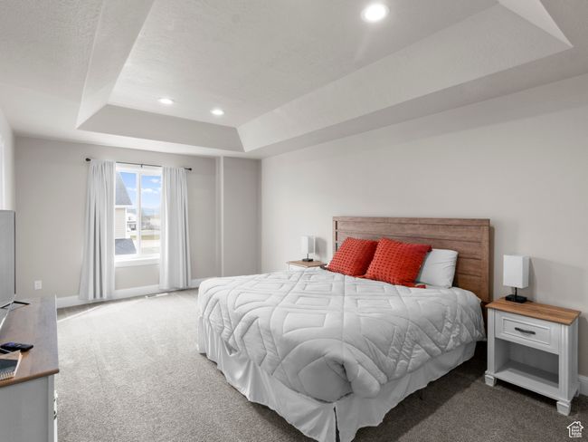 Carpeted bedroom featuring baseboards, recessed lighting, and a tray ceiling | Image 10