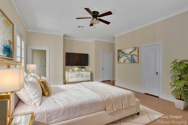 Bedroom with ornamental molding, wood finished floors, and a ceiling fan | Image 20