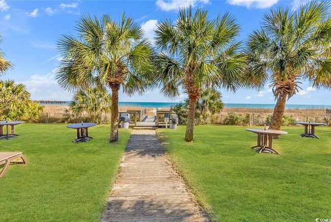 View of community featuring a yard and a water view | Image 26