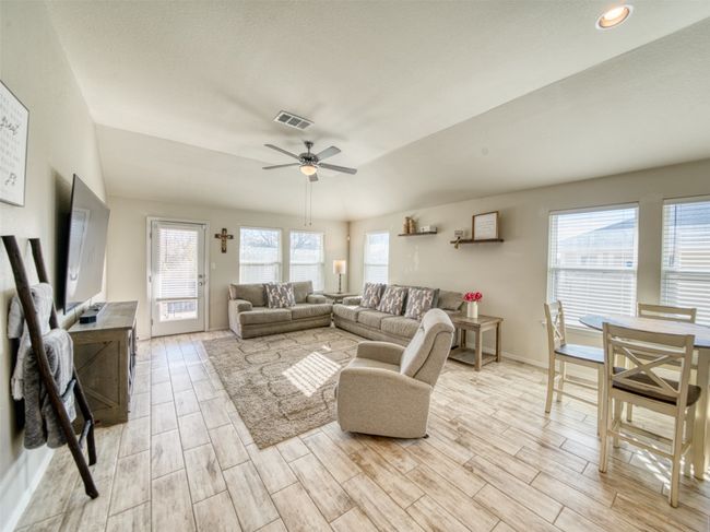 Living room featuring ceiling fan and lofted ceiling | Image 4