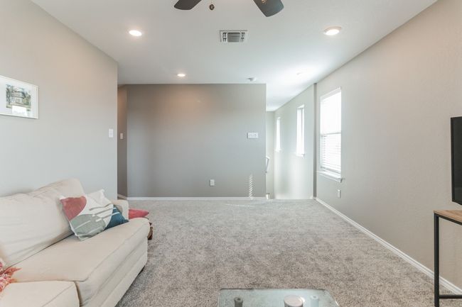 Living room with carpet, a ceiling fan, and recessed lighting | Image 18