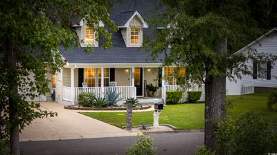 View of front facade featuring a front yard and covered porch | Image 2