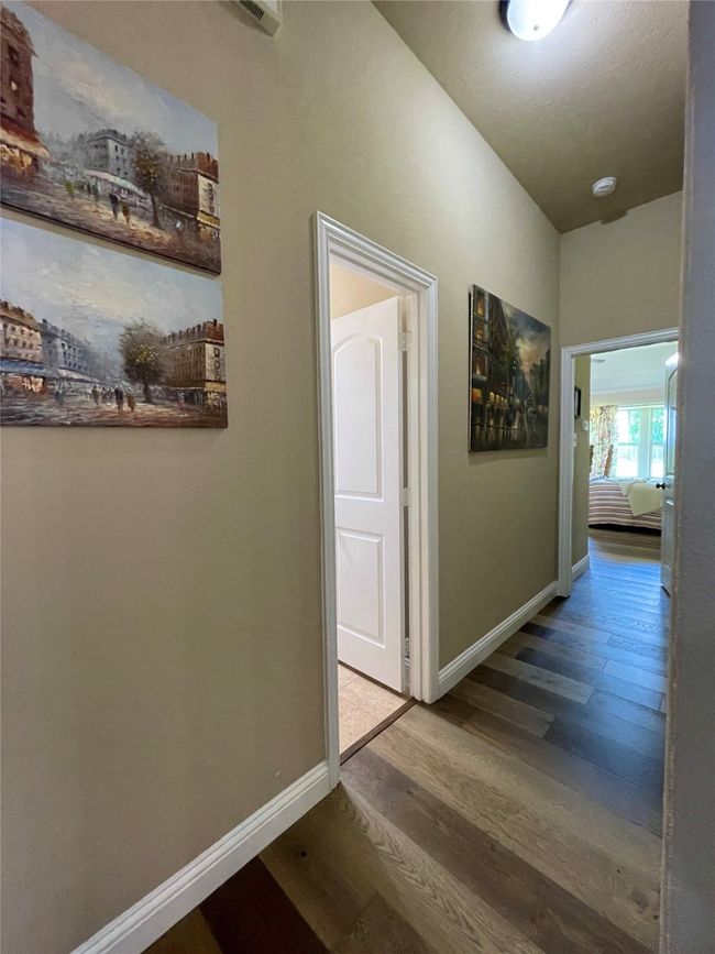 Hall featuring wood finished floors and baseboards | Image 18
