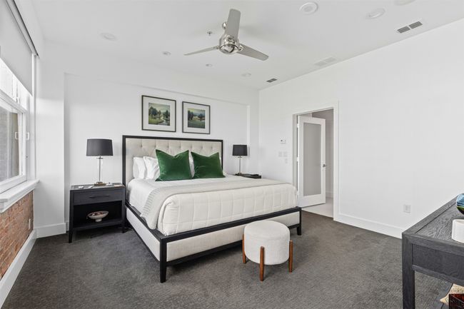Bedroom with dark carpet, visible vents, baseboards, and ceiling fan | Image 17