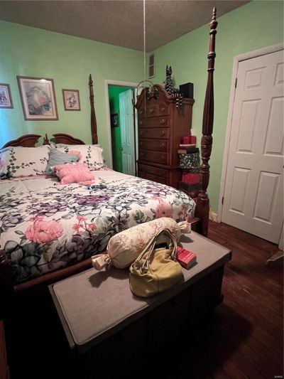 Bedroom featuring dark hardwood / wood-style flooring | Image 2