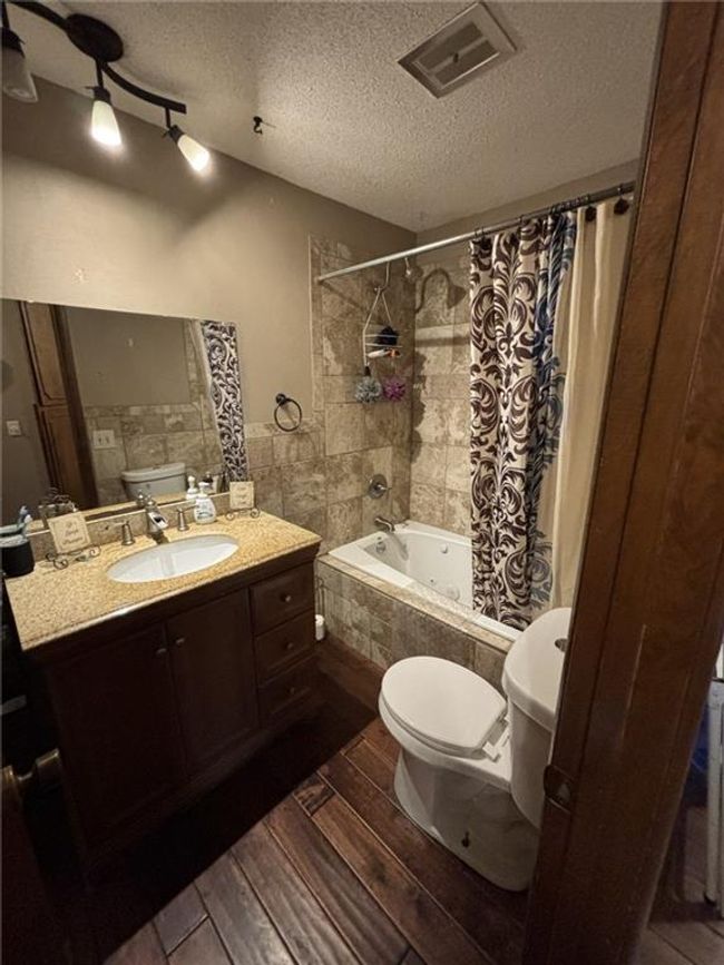 Bathroom #3 featuring wood finished floors and tiled shower / bath | Image 25