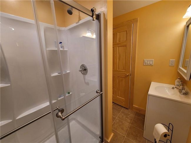 Bathroom featuring tile flooring, enclosed tub / shower combo, and vanity | Image 19
