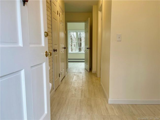 Mudroom Entry with tiled floor, remodeled powder room, looking toward laundry room | Image 10
